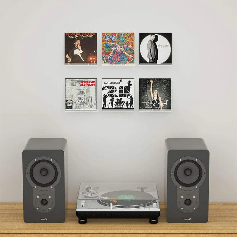 6 clear acrylic record shelves on wall over a record player and speakers