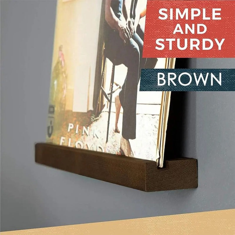 a record shelf with single groove on a wall holding a vinyl record